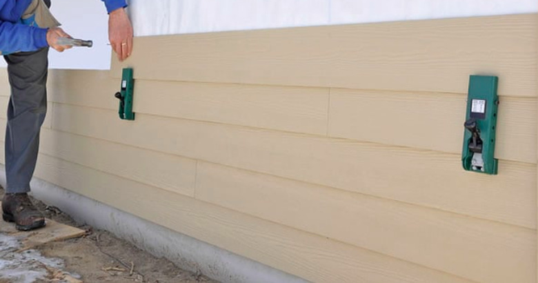 Installing fiber cement planks siding.