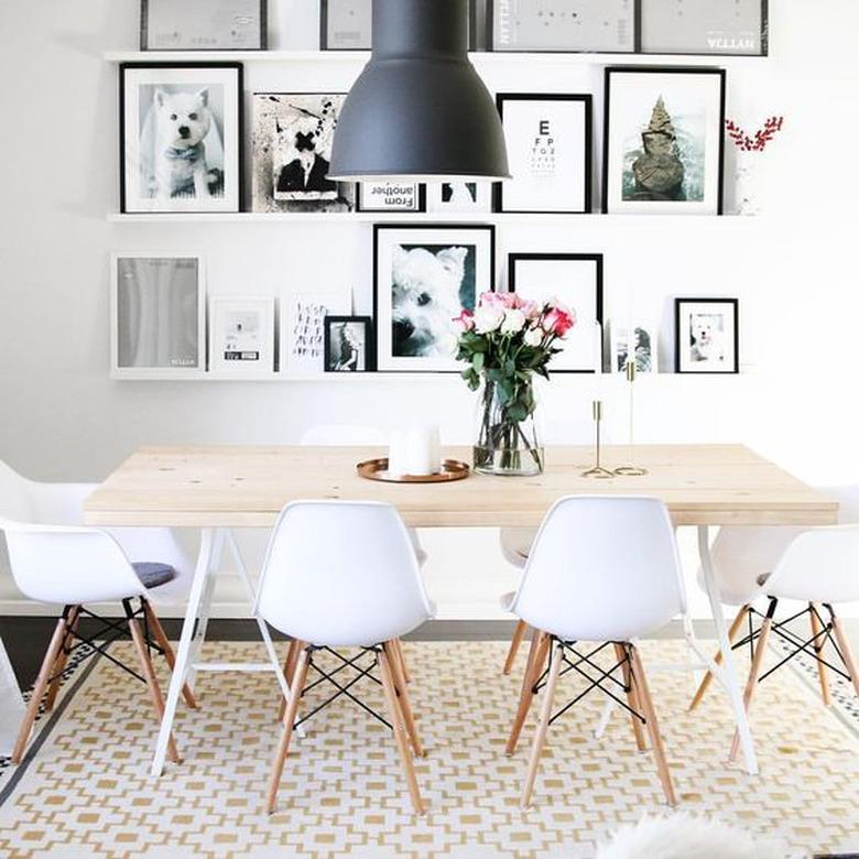 floating dining room shelves from IKEA filled with artwork and photographs