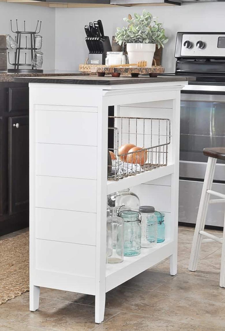 Small white bookshelf turned kitchen island on tile floors