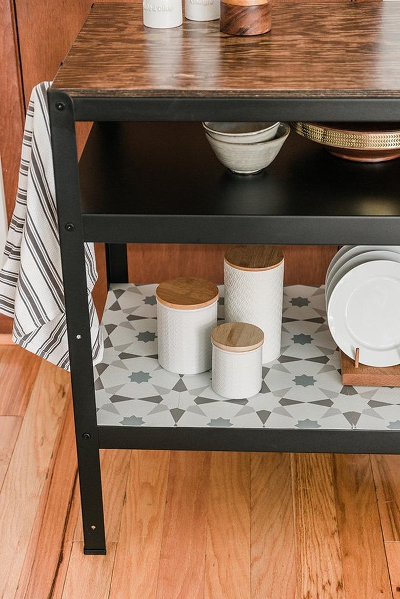 IKEA workbench as a kitchen island with wood counter and hooks.