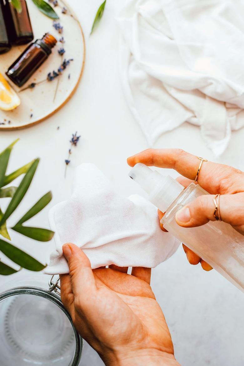 Spray liquid mixture onto dusting cloths