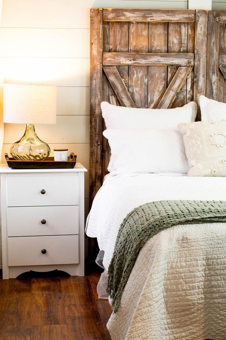 barn door DIY rustic headboard in farmhouse bedroom