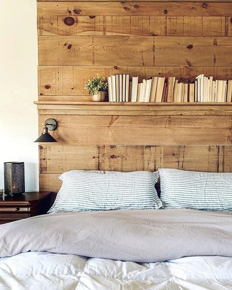 DIY rustic headboard with shelf and wall sconces