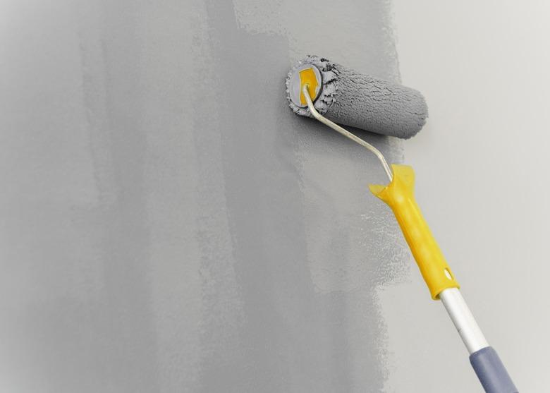 Wall painting with roller concept,Close-up of paint roller on wall