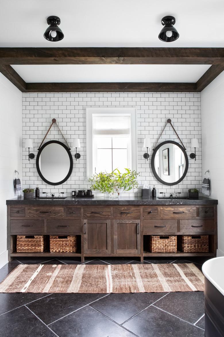 modern bathroom with oval hanging mirrors over double vanity