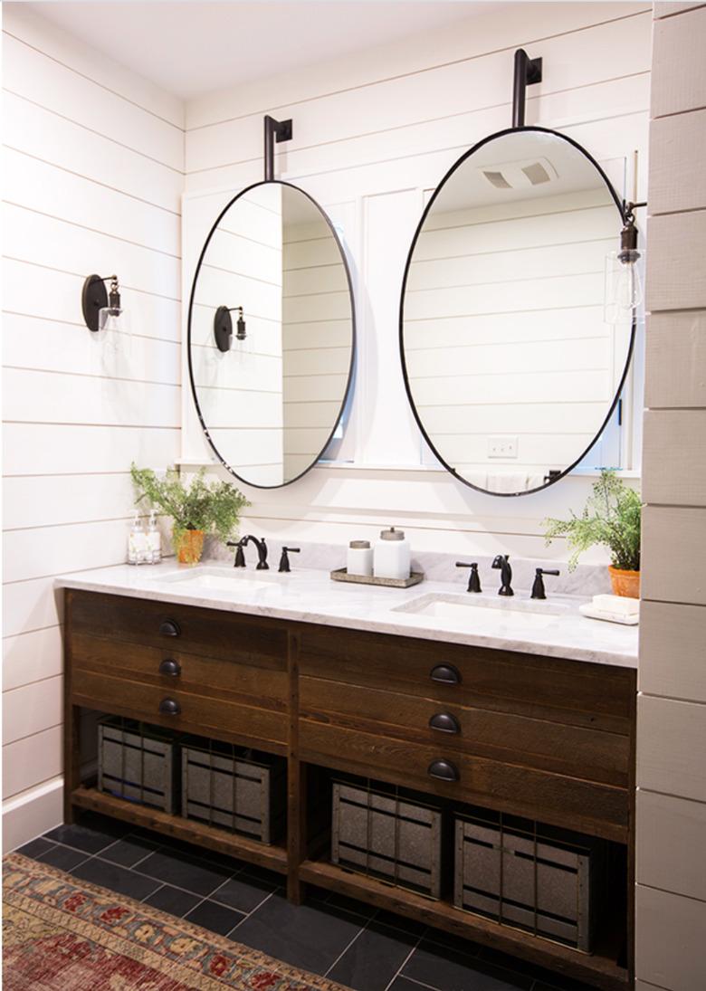 bathroom with oval mirros over double vanity