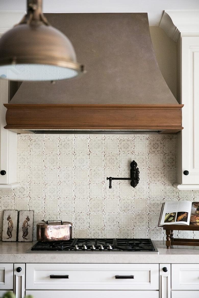 neutral patterned tile kitchen backsplash with antique details