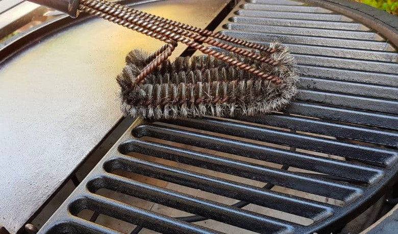 Cleaning a cast iron grate.