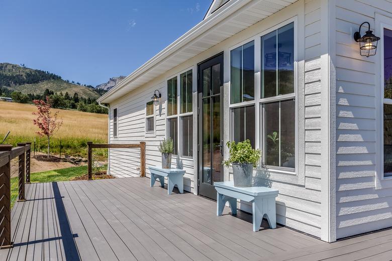 Back wrap around porch with white fiber cement siding