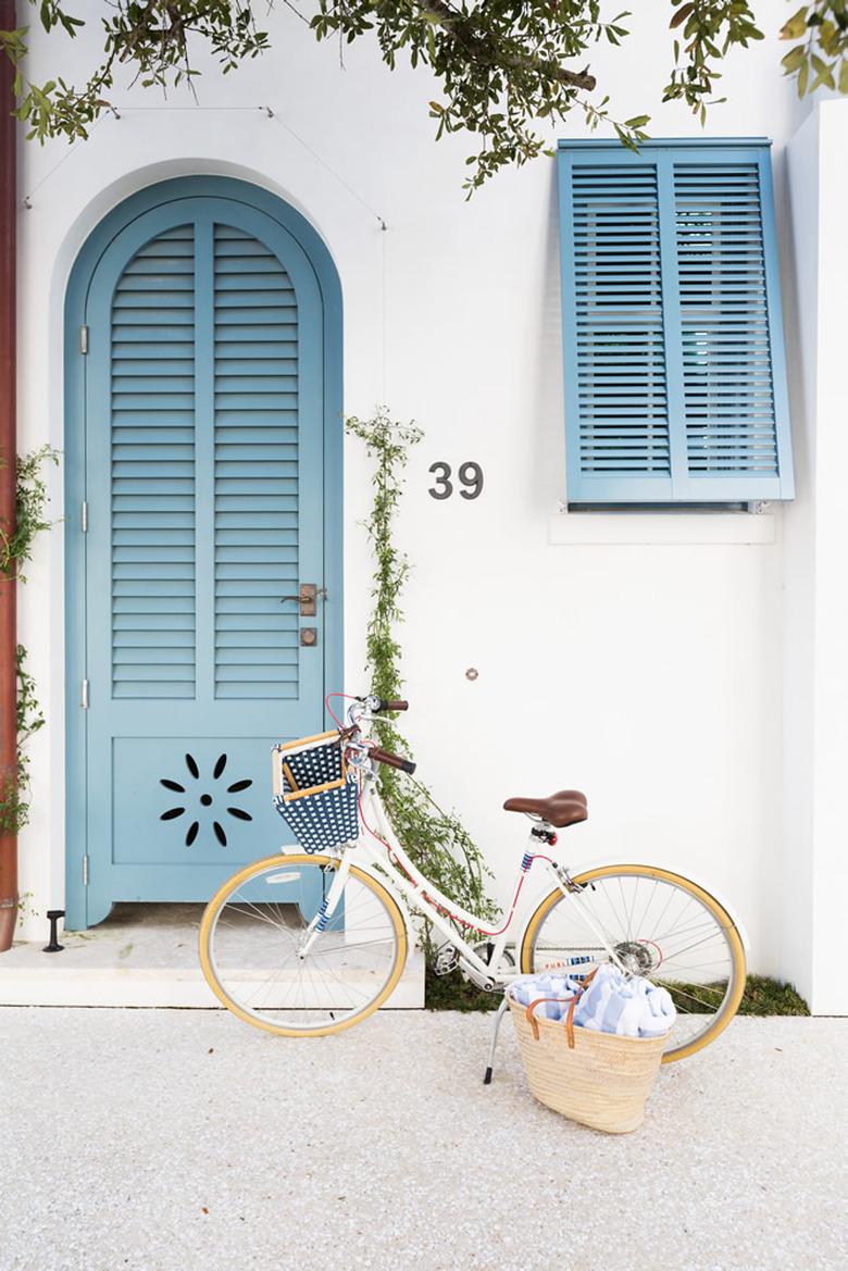 Blue exterior house shutters with shutter-inspired blue door