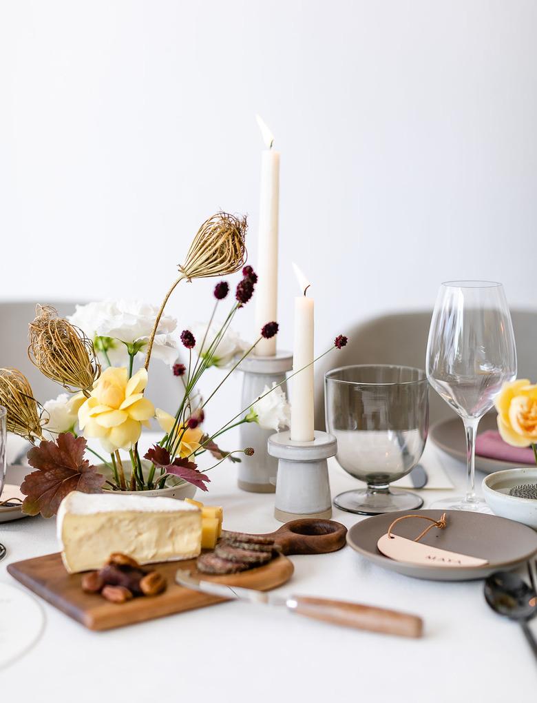 Minimalist fall centerpiece with dried florals alongside cheeseboard