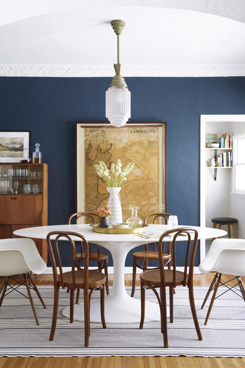 dining room table with brass tray on white tulip table