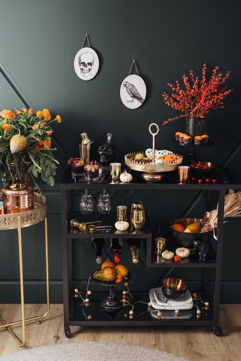 small fall pumpkins on black bar cart