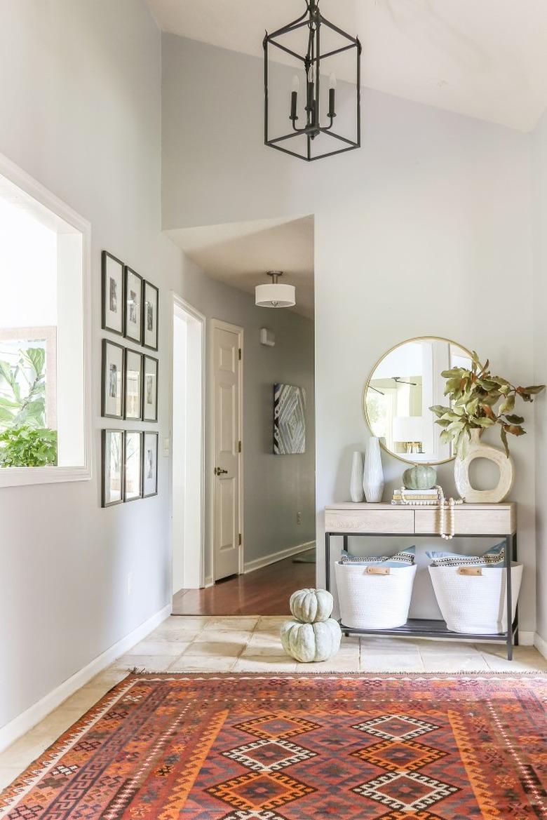 light green fall pumpkins in entryway with patterened rug