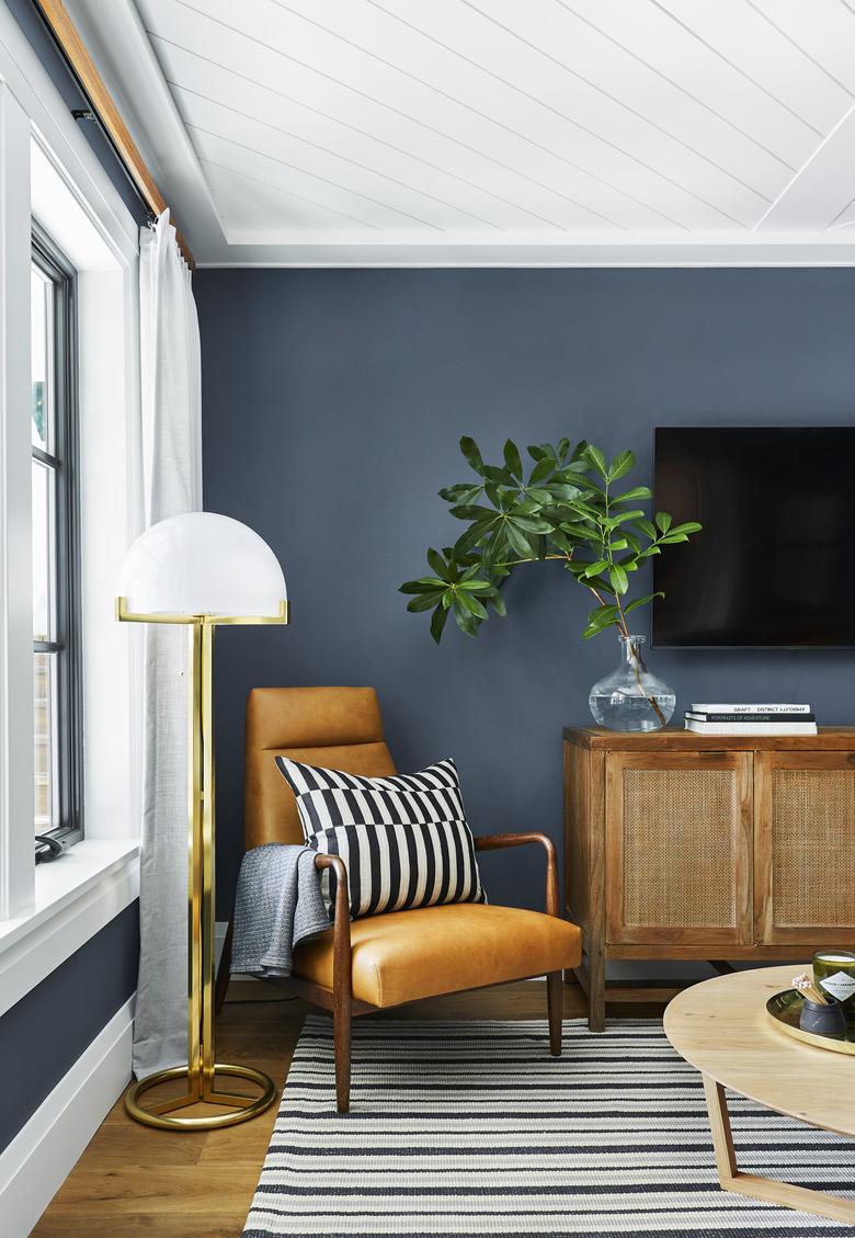 Navy blue family room paint colors with leather chair.