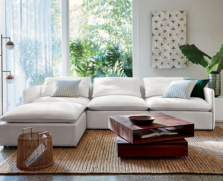 family room storage coffee table with white sectional couch and jute rug.