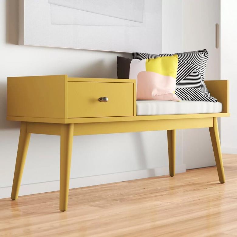 family room storage with yellow bench with drawer, throw pillows, white cushion and wood floors.