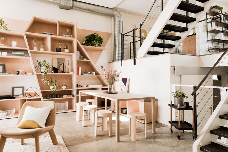 family room storage with plywood built-in shelving, side chair, light wood dining set