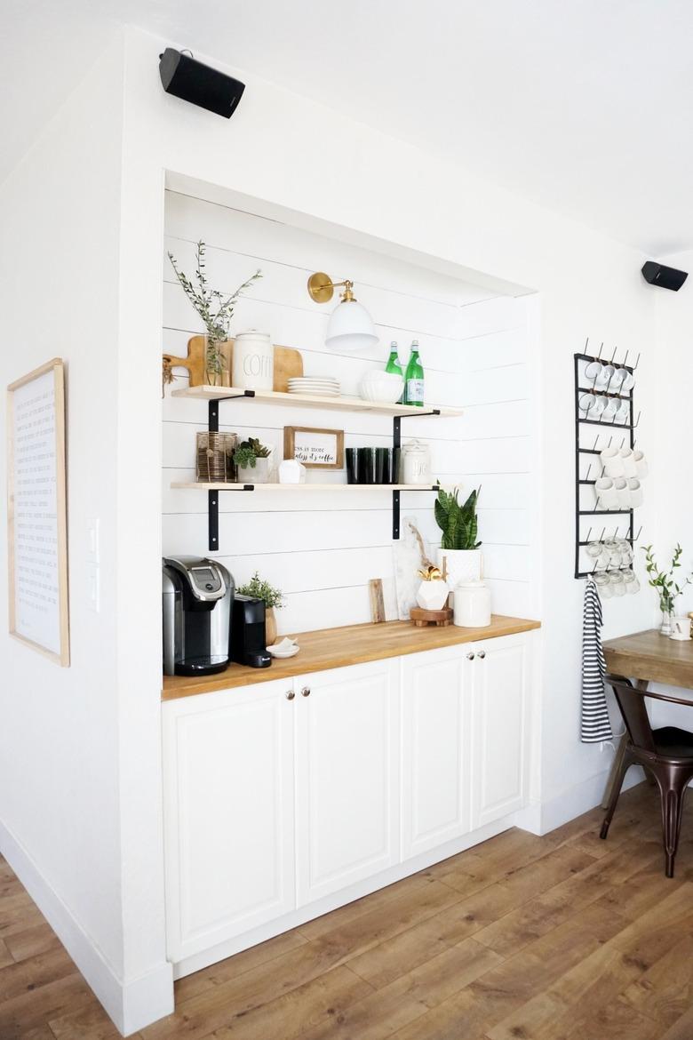 Farmhouse coffee bar with white shiplap and white cabinets in family room