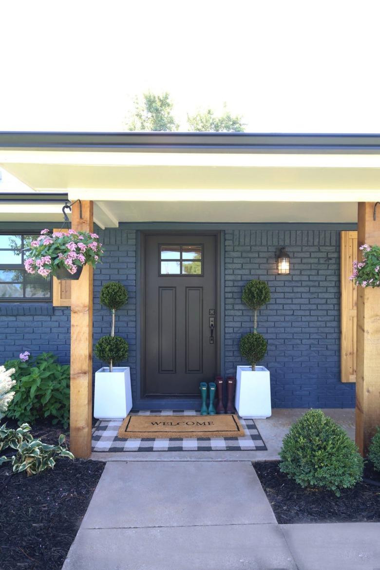 navy blue farmhouse exterior with wood posts