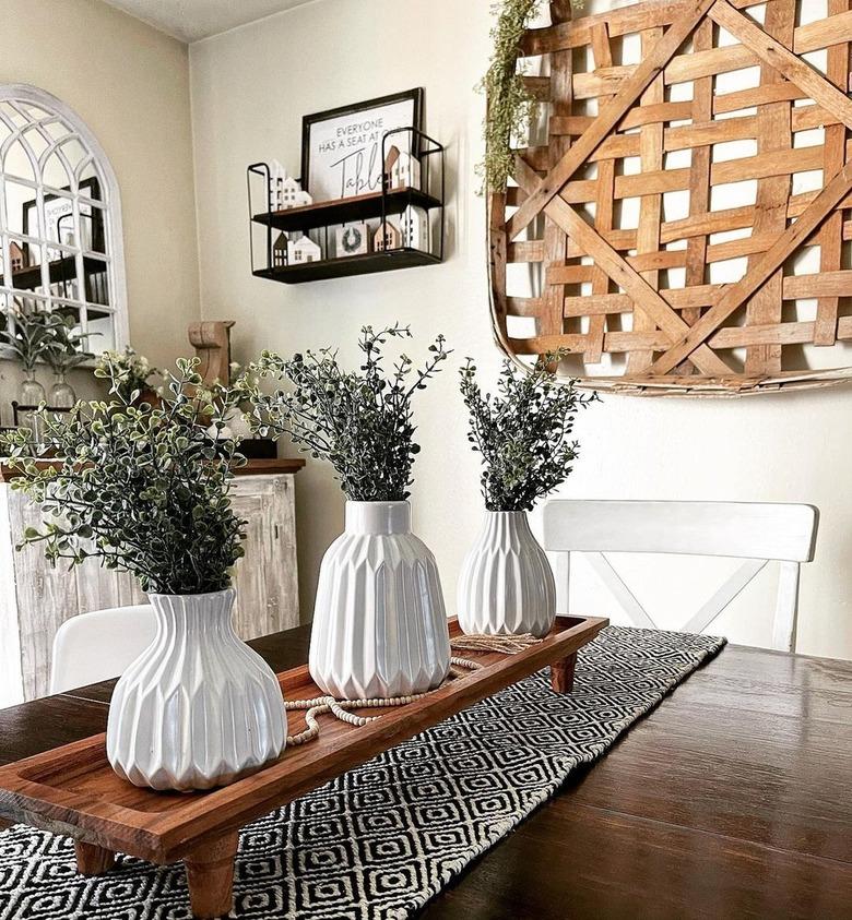 centerpiece with three flower arrangements on long wooden tray