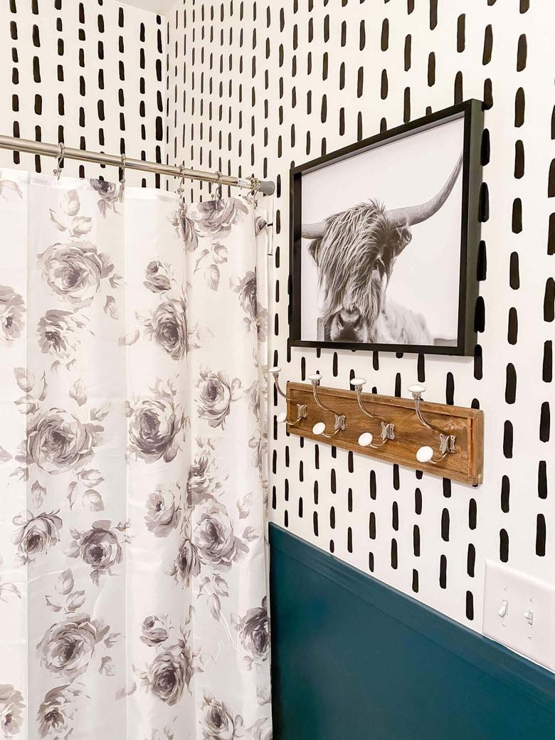 bathroom with black and white photo and modern wallpaper