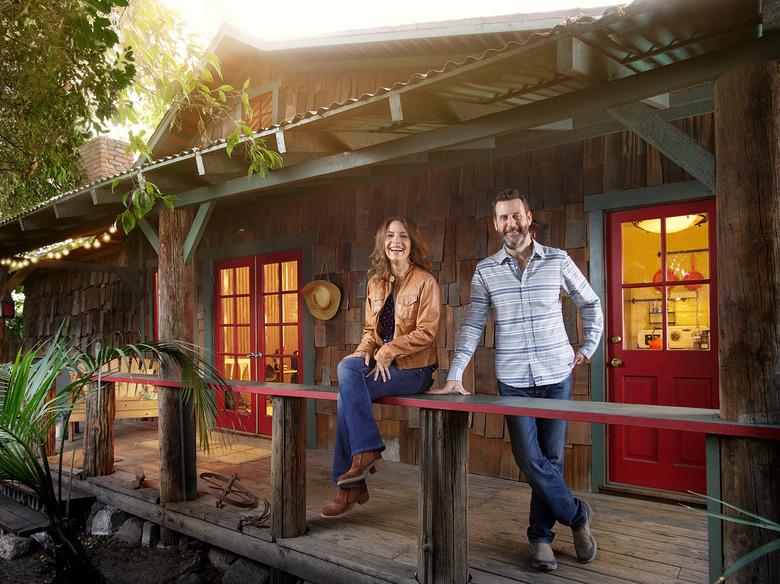 homeowners pose outside house