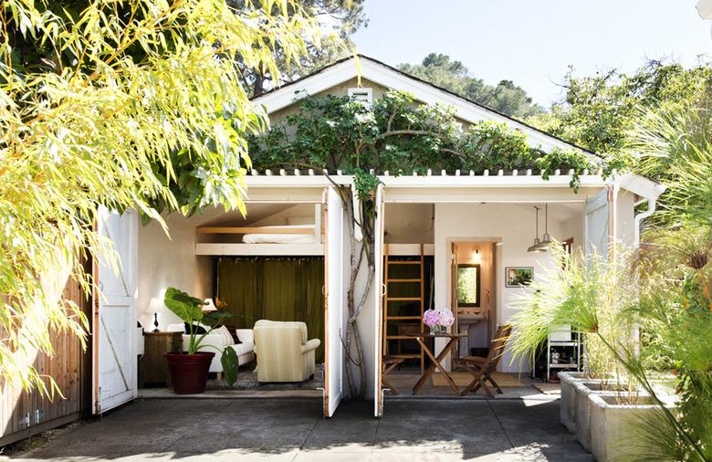 converted garage bedroom idea surrounded by trees