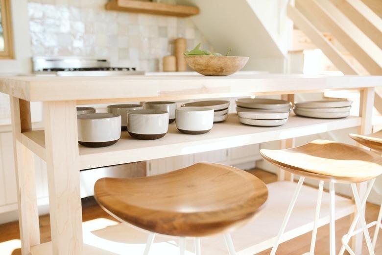 flatware and wooden bar stools with wooden kitchen island