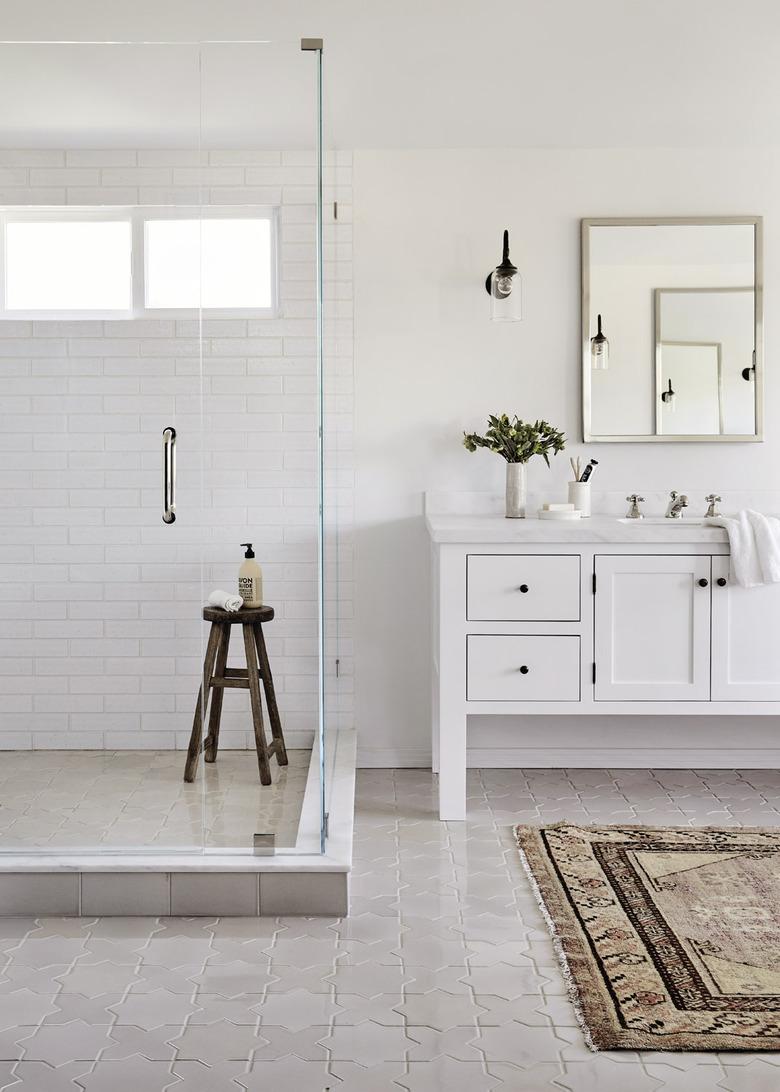 white bathroom with frameless glass shower door