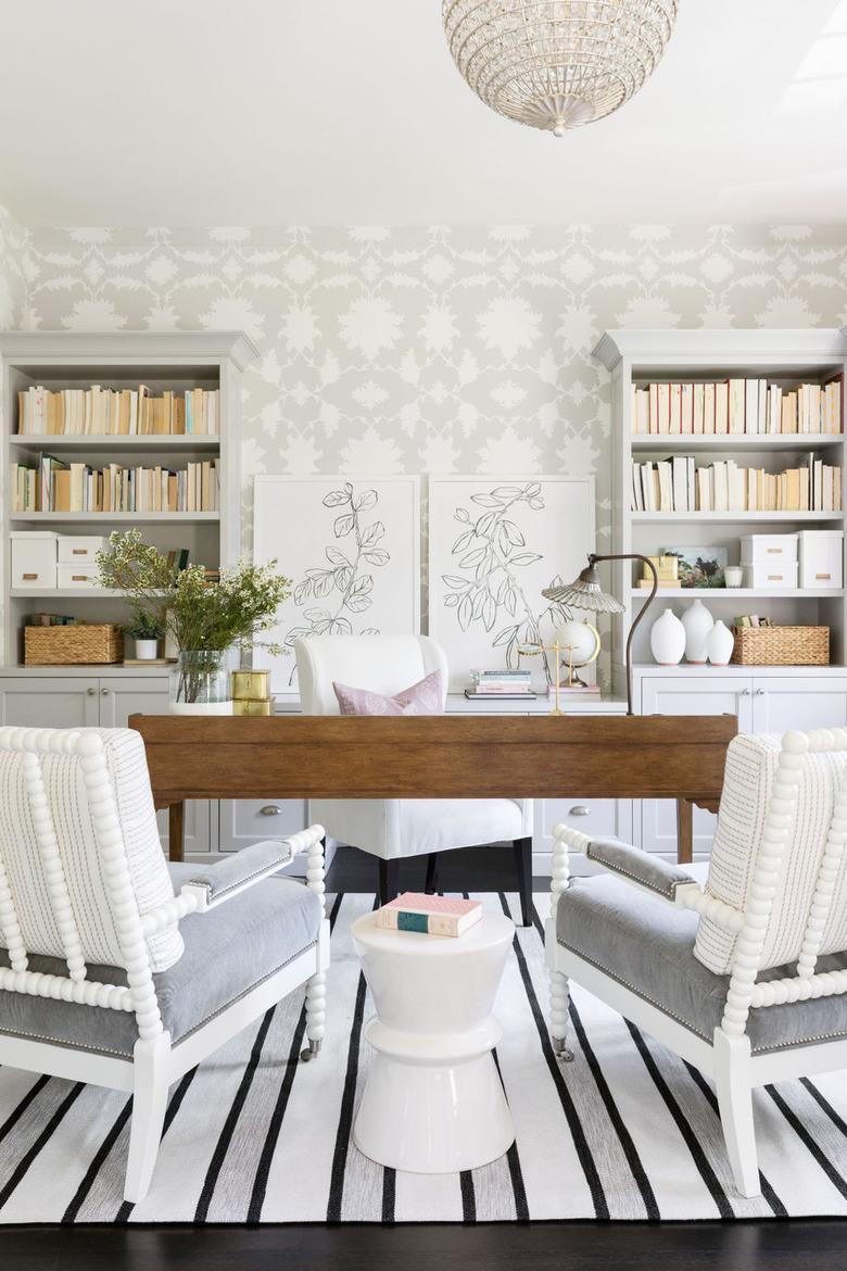 gray home office with gray and white floral wallpaper and wood desk