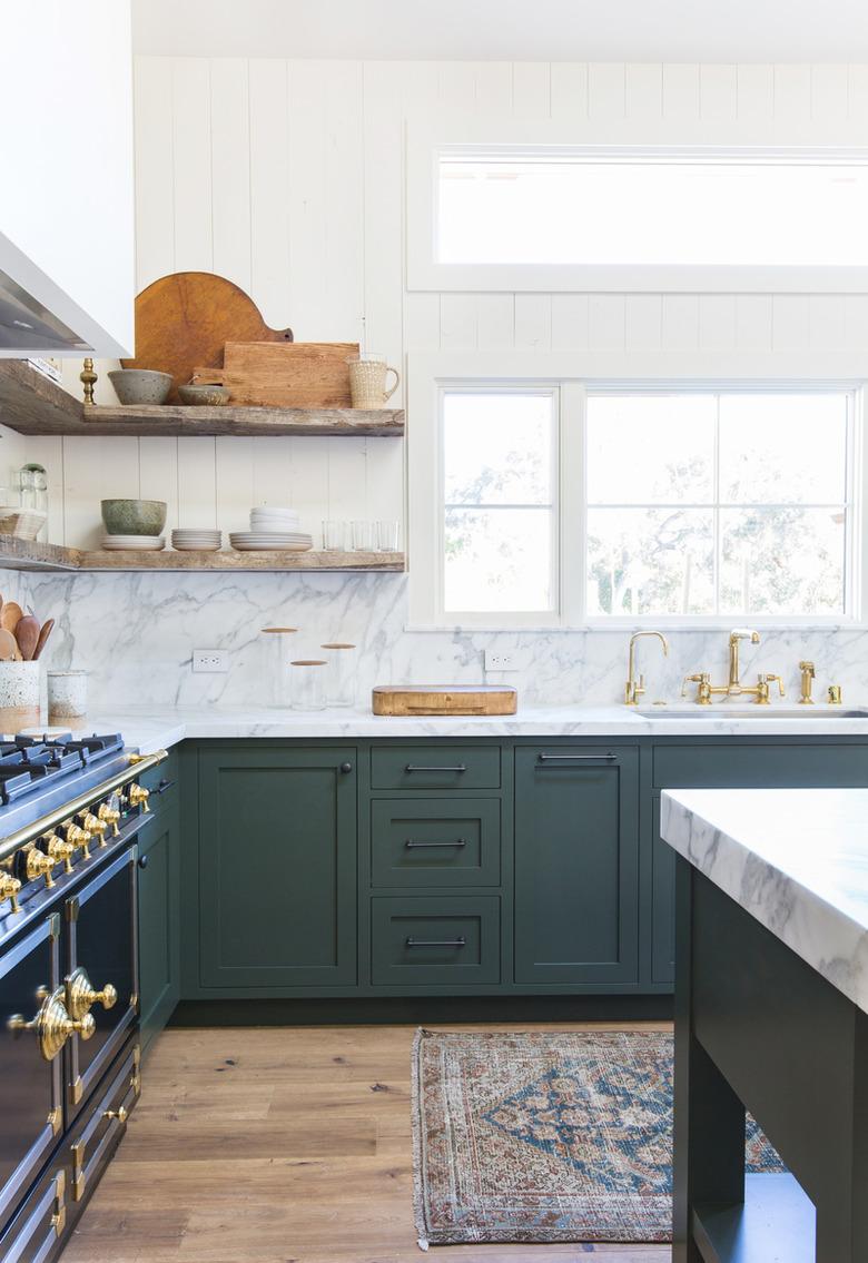 modern kitchen with green cabinets and open shelving