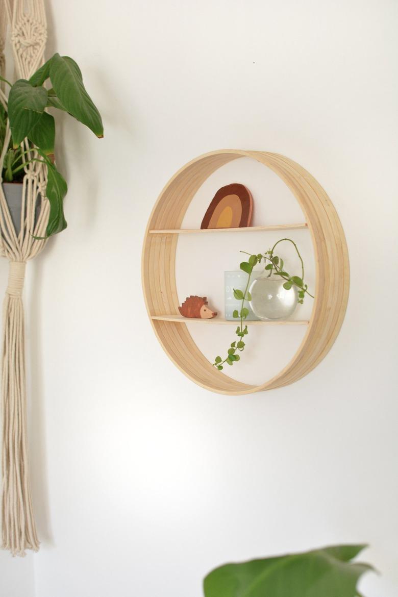 Wood circle shelf made from embroidery hoops hung on wall