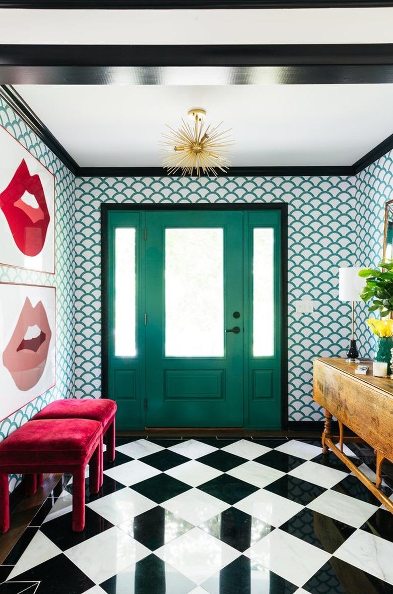 Hallway Pendant Light in Maximalist hallway with black and white floors, wallpaper, art, benches, gold light, credenza, green door.