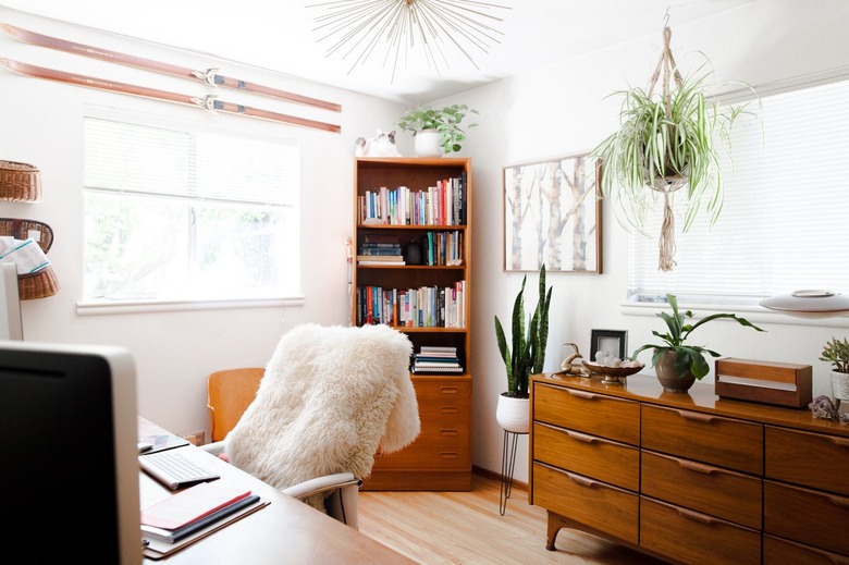 Office with sheepskin draped over desk chair, dresser, corner shelf, hanging plant with Home Office Desk Ideas