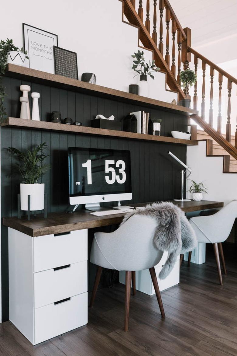 modern home office with black shiplap wall and wood top desk