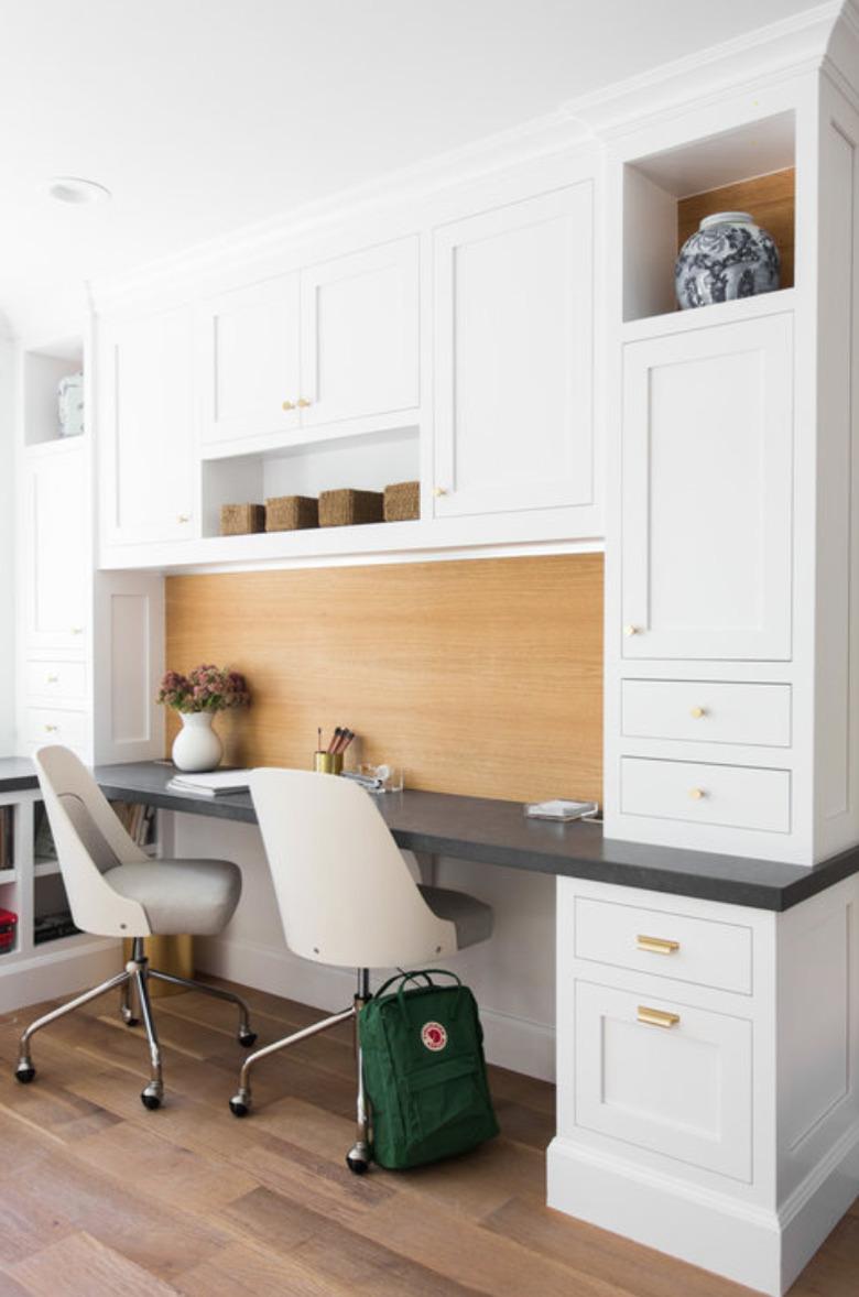 Home Office for Two White built in cabinets with desk, white desk chairs.