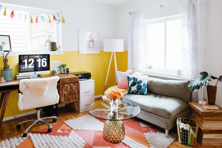 yellow home office with colorblocked walls and wood desk