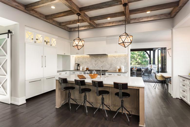 beautiful kitchen in new luxury home with island and pendant light fixtures