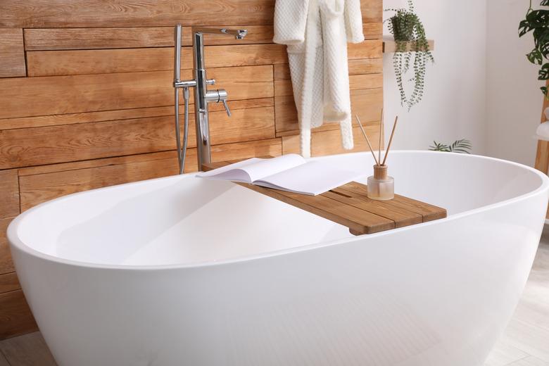 White tub and beautiful plants in bathroom, Interior design