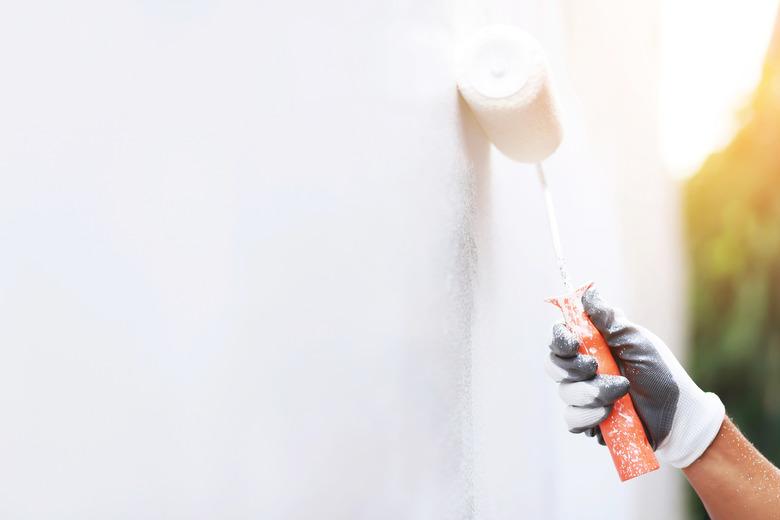 Painter is painting the interior wall white