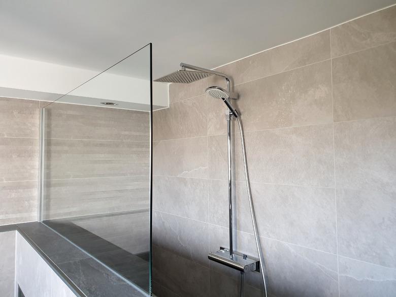 Modern rain shower with glass wall in the bathroom