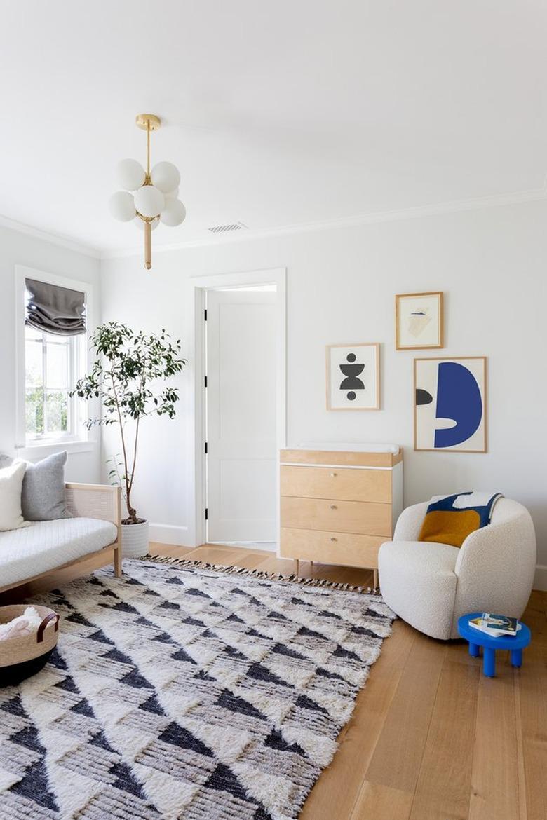 minimalist with color in white room with rug and lounge chair