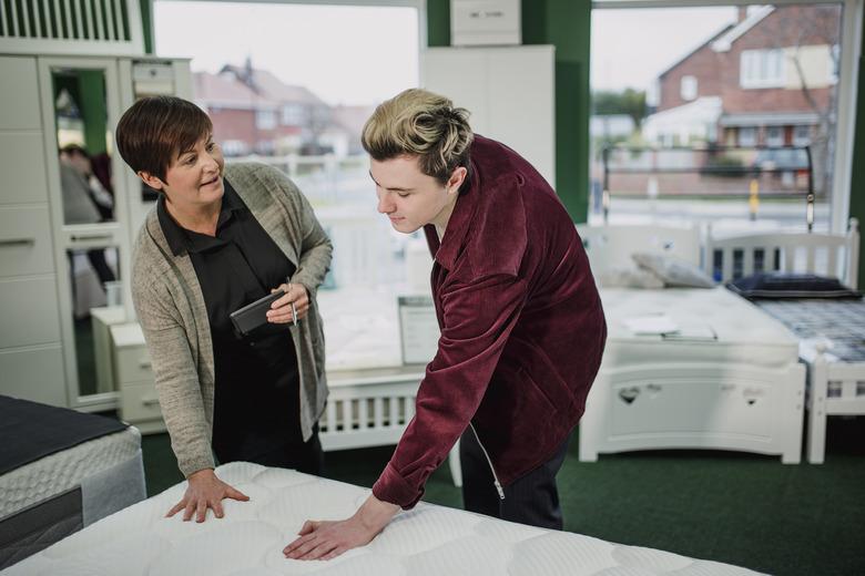 Young man shopping for a new mattress