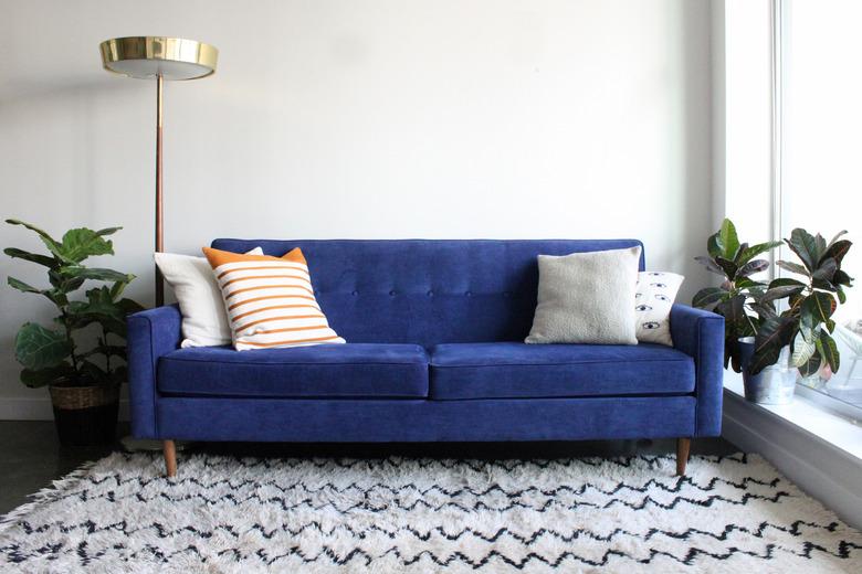 Blue Suede Mid Century Modern Couch in Minimalist Apartment Setting