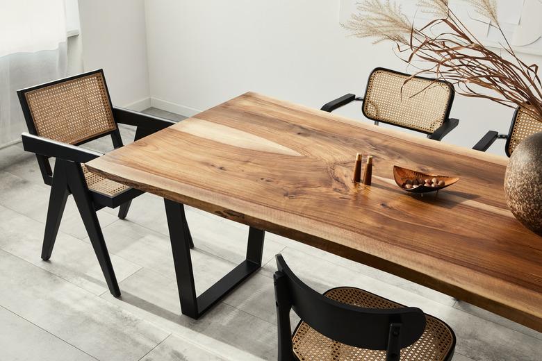 Dining room interior with wooden table and modern chairs.