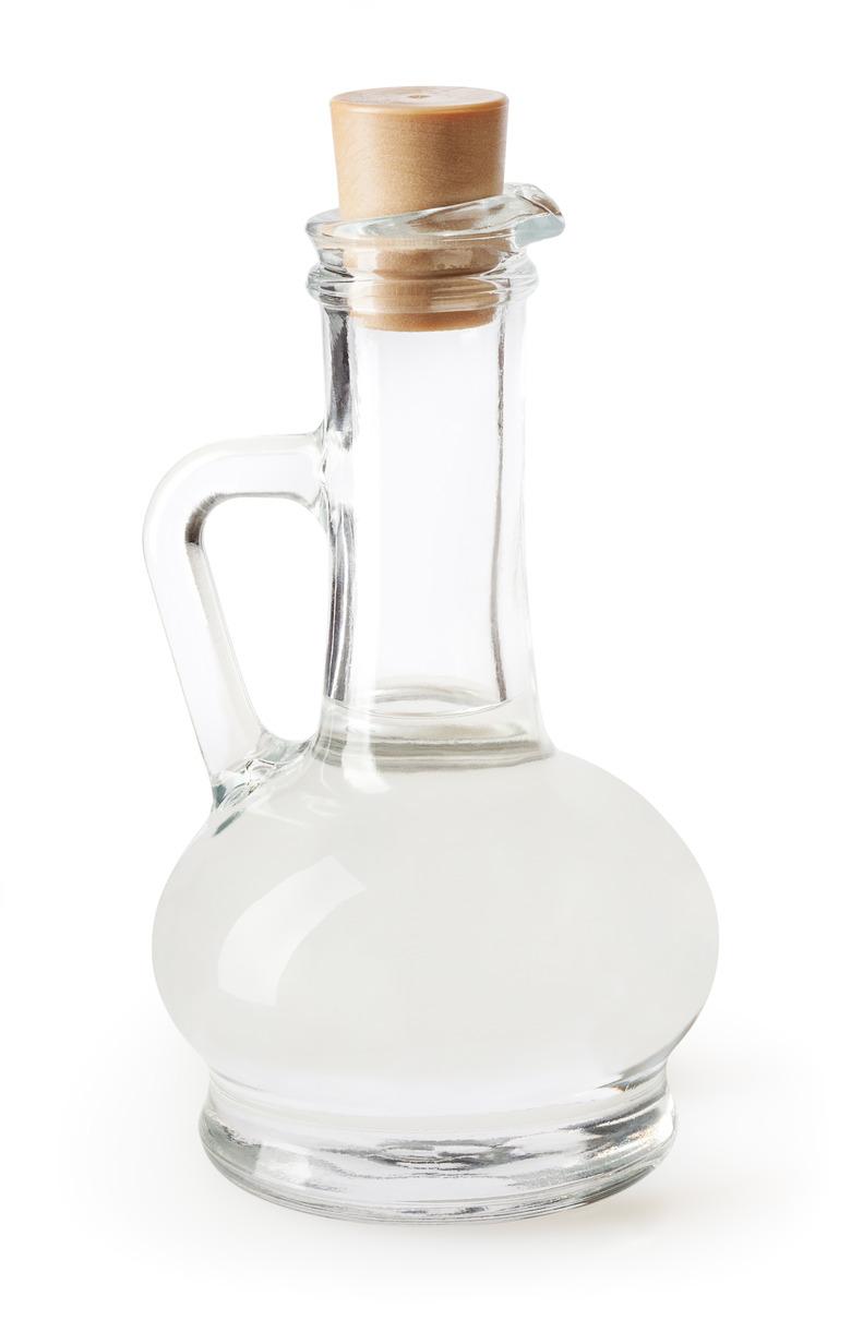 White vinegar in glass bottle isolated on white background with clipping path