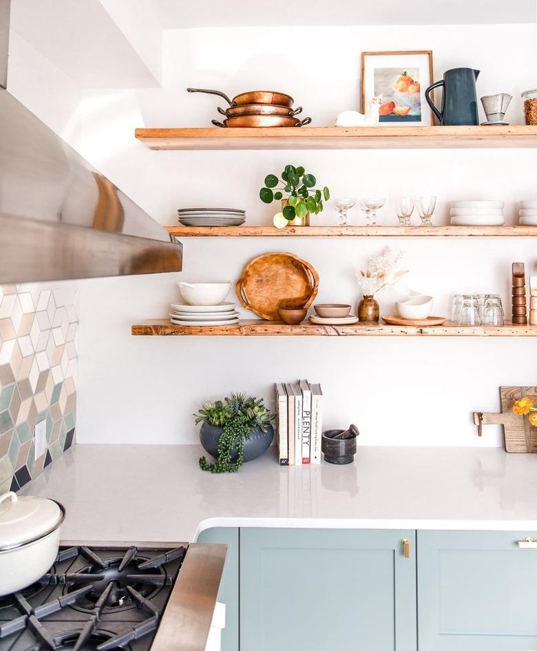 coppe pots and pans displayed on shelving