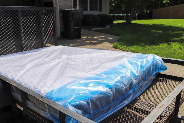 A new mattress being delivered on a truck