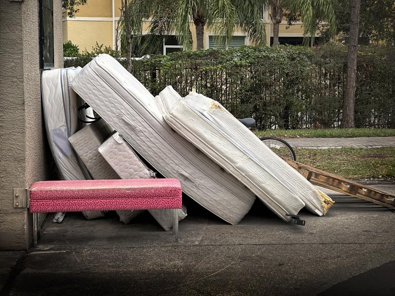 Furniture and mattresses at garbage dump area